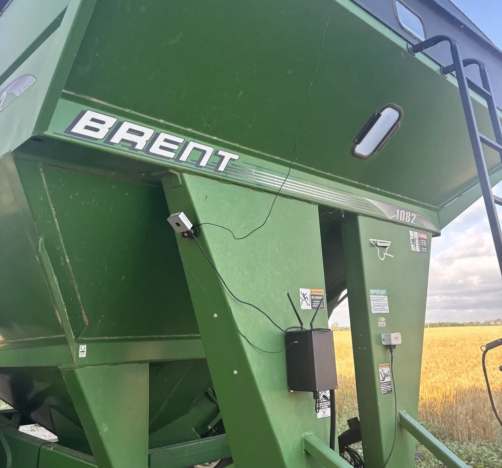 StoneSight AI unit and logger box mounted on a grain cart at harvest